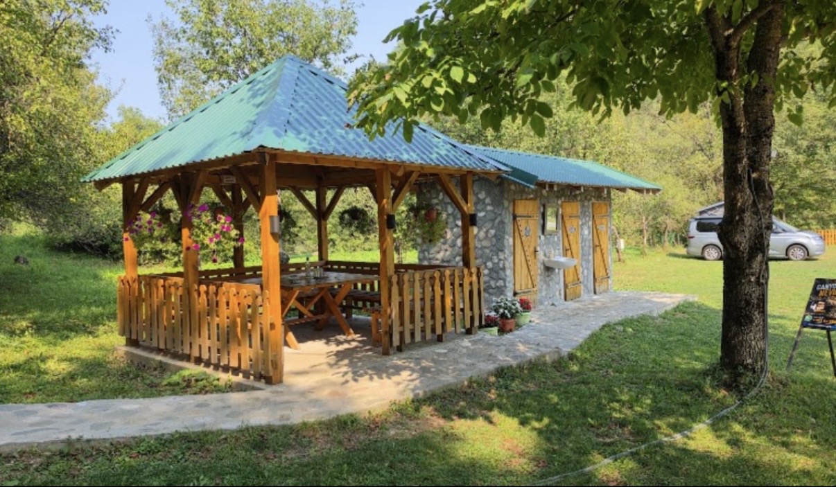 Wooden pavilion in a green camp